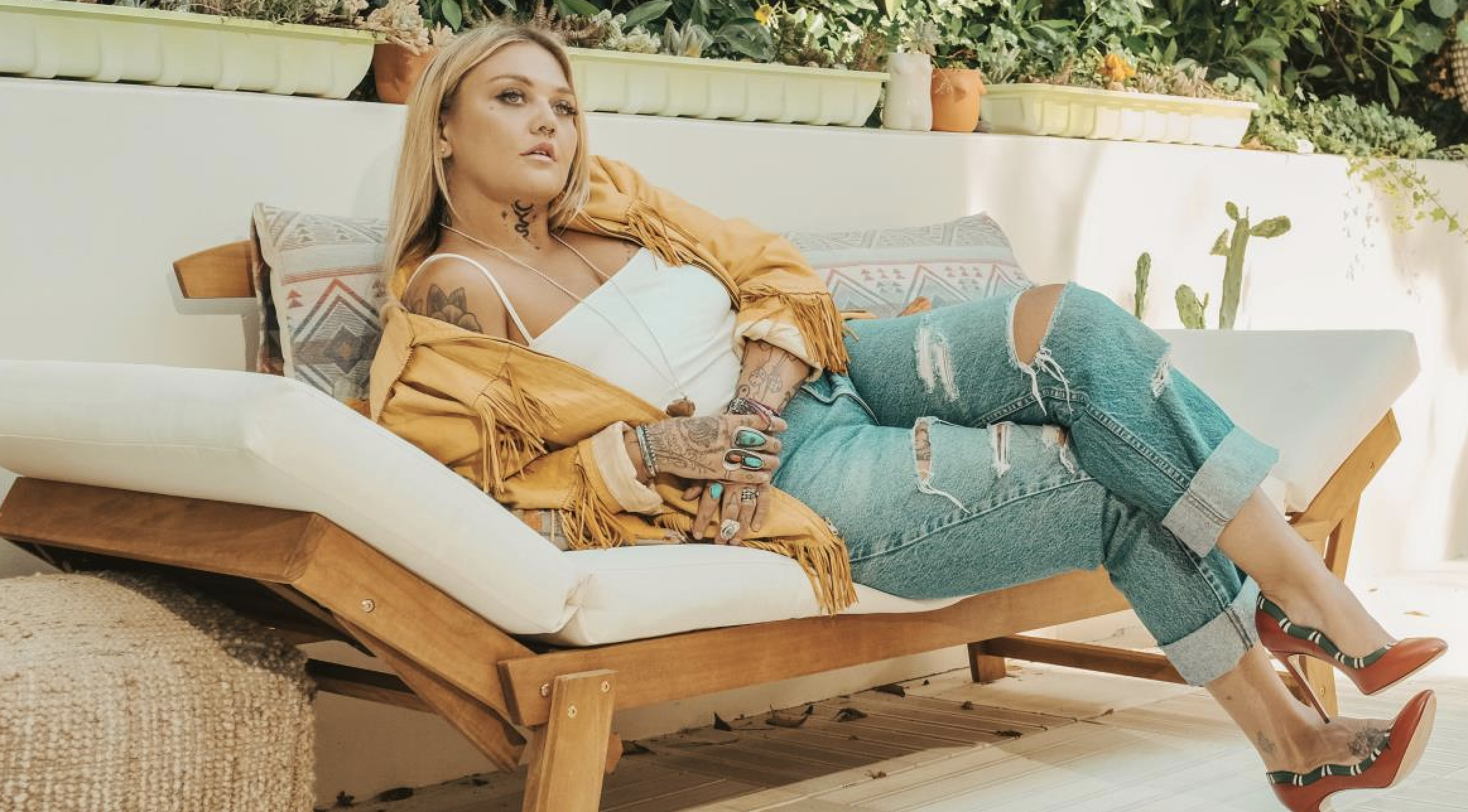 Elle King on a couch.