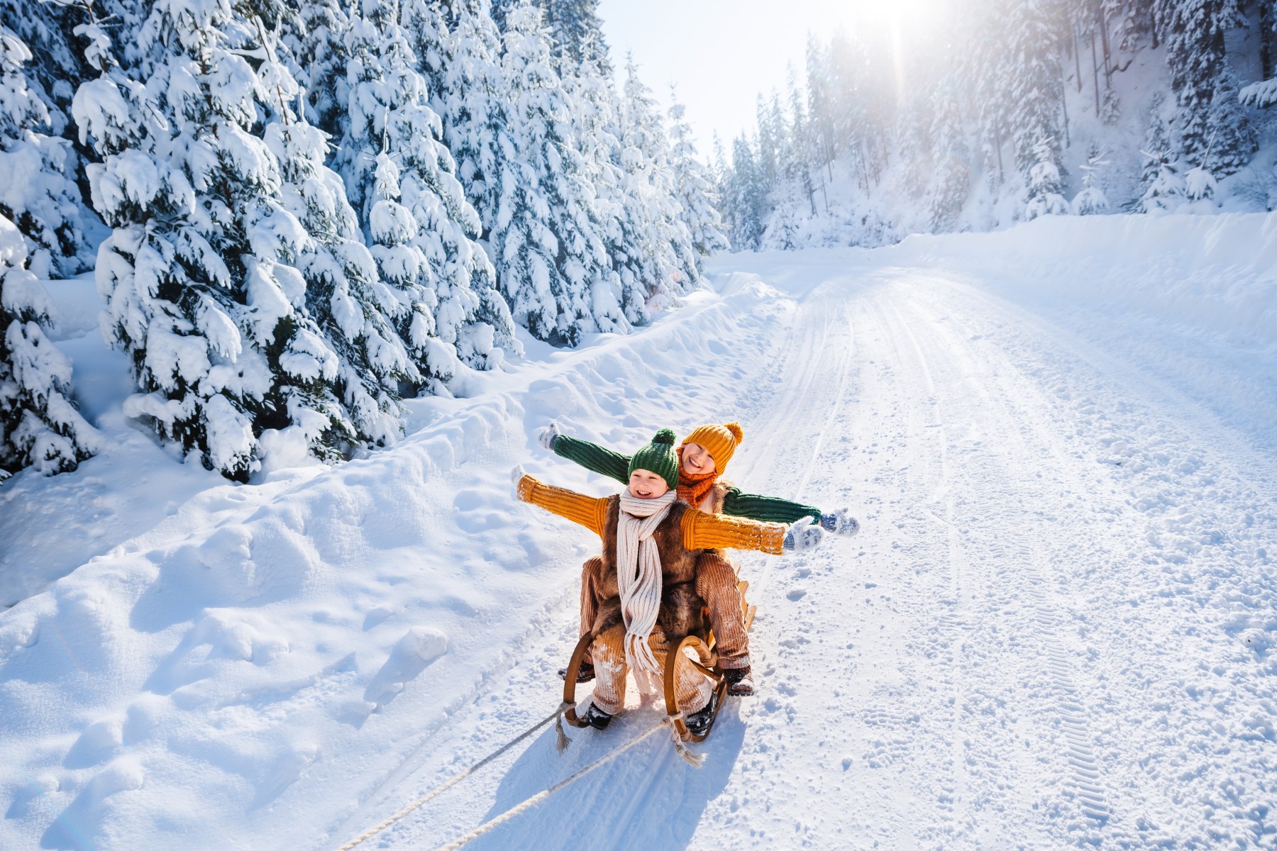 kids sledding in snow